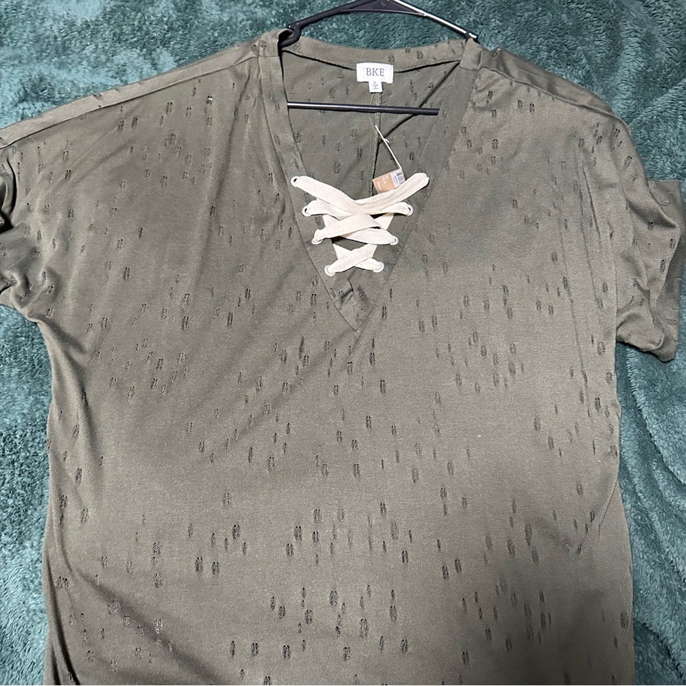Distressed lace up buckle top